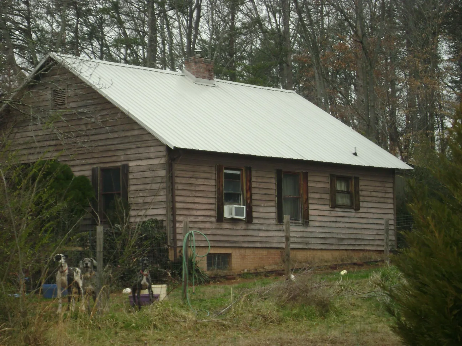White metal roof on an old wood sided farmhouse, from a Metal Roof Installation job in Pownal